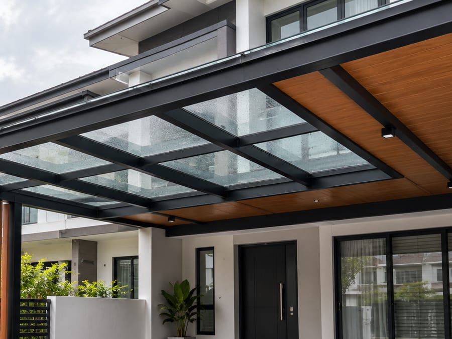 Illustration of a glass roof on a black steel frame over a car porch after rain, with a wood-grain aluminium ceiling along the house side of it.